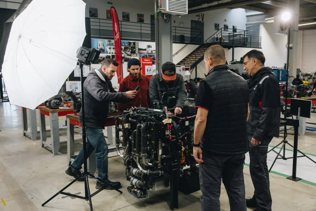 2026-renault-trucks-makers-bts-28 Équipe de tournage filmant un moteur installé dans un atelier Renault Trucks.
