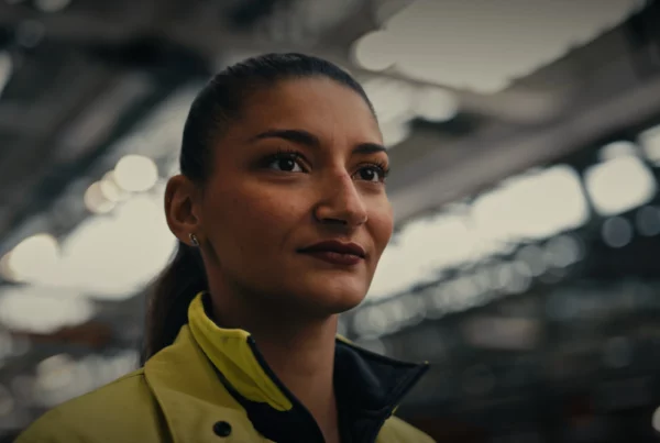 Portrait d’une opératrice en tenue de travail dans un atelier Renault Trucks.